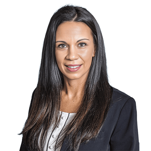 Woman with long straight dark hair, wearing a black blazer over a white top, facing forward and smiling against a plain white background, reflects professionalism ideal for Construction Management roles in Southwest Florida.