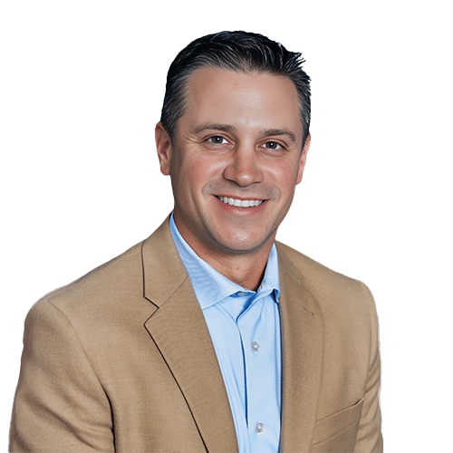 Man wearing a light brown suit jacket and light blue shirt, smiling, with short dark hair, posed in front of a plain white background—perfectly capturing the professional spirit of Southwest Florida Construction Management.